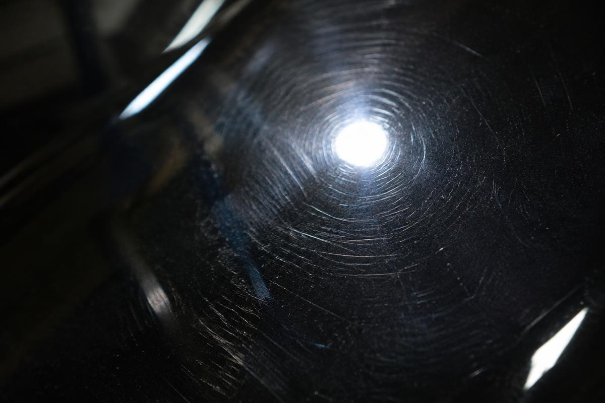 Paint surface with fine swirl marks before correction (placeholder image)